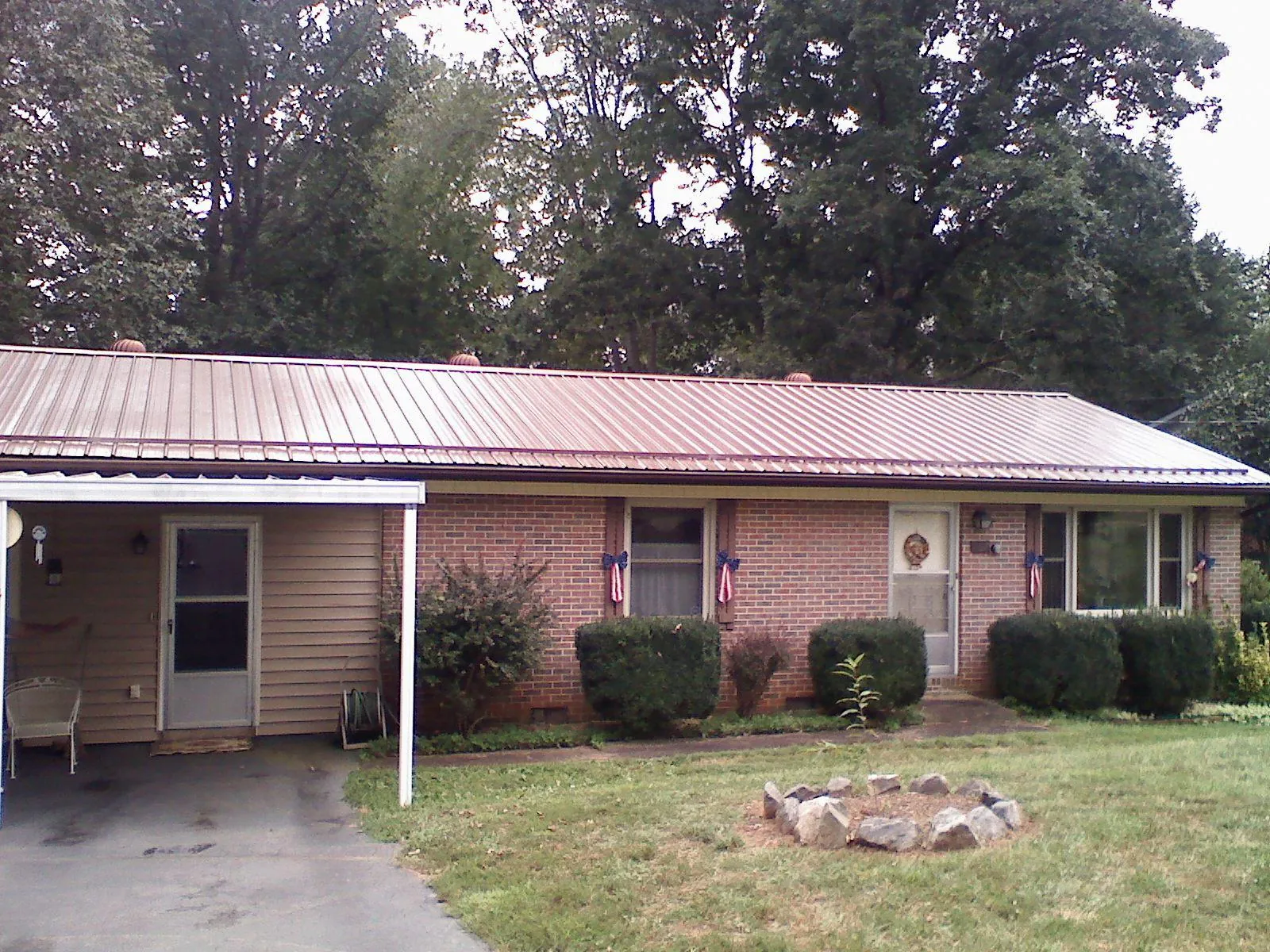 Bronze metal roof and carport on a brick ranch home — Roof Repair work by our crew in Walnut Creek